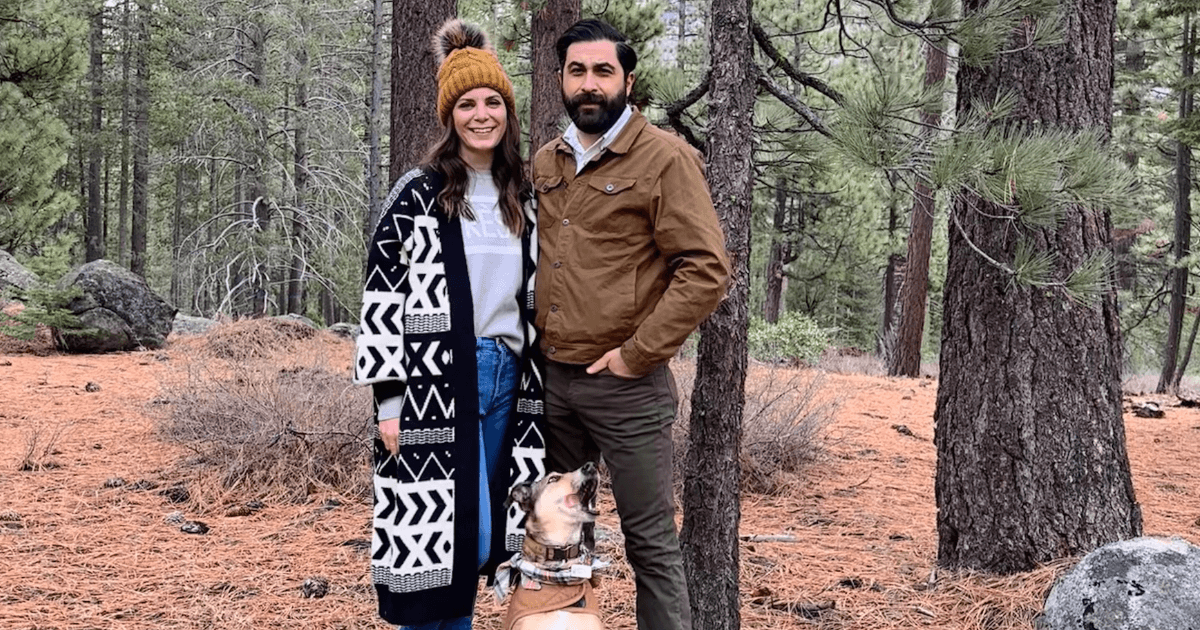 Josh and Kristy Bottini are joined by their dog on a hike through the woods.